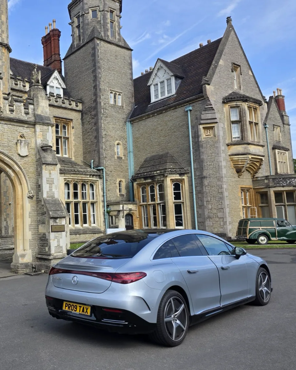 Proline silver Mercedes-Benz EQE arriving at a country house hotel on a long-distance chauffeur transfer from Bristol