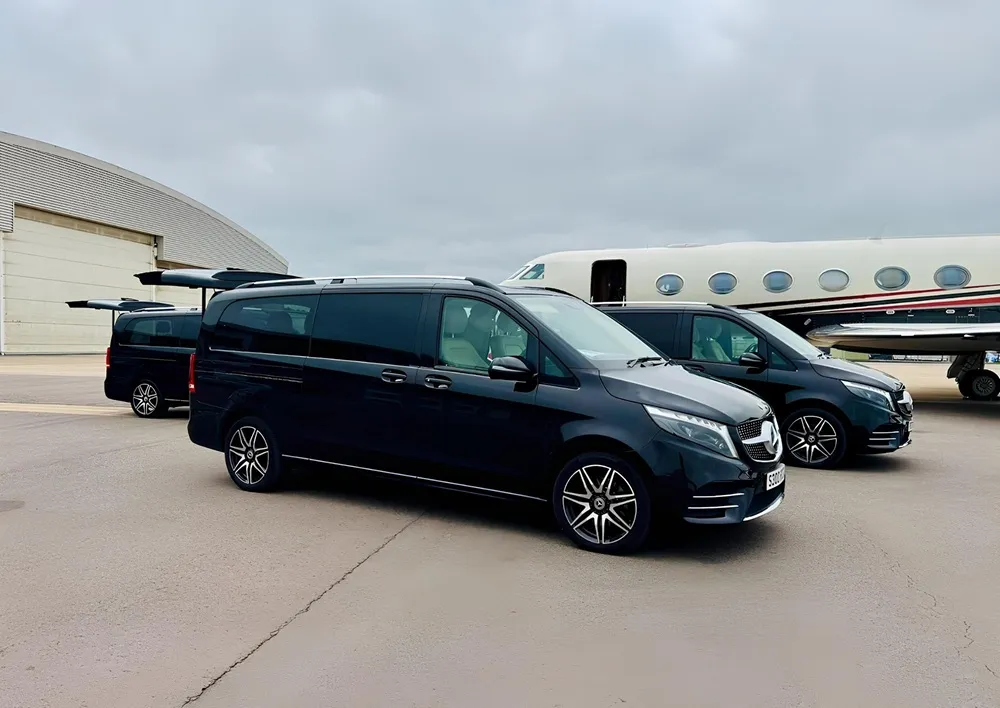Three Proline Mercedes V-Class vehicles beside a private jet
